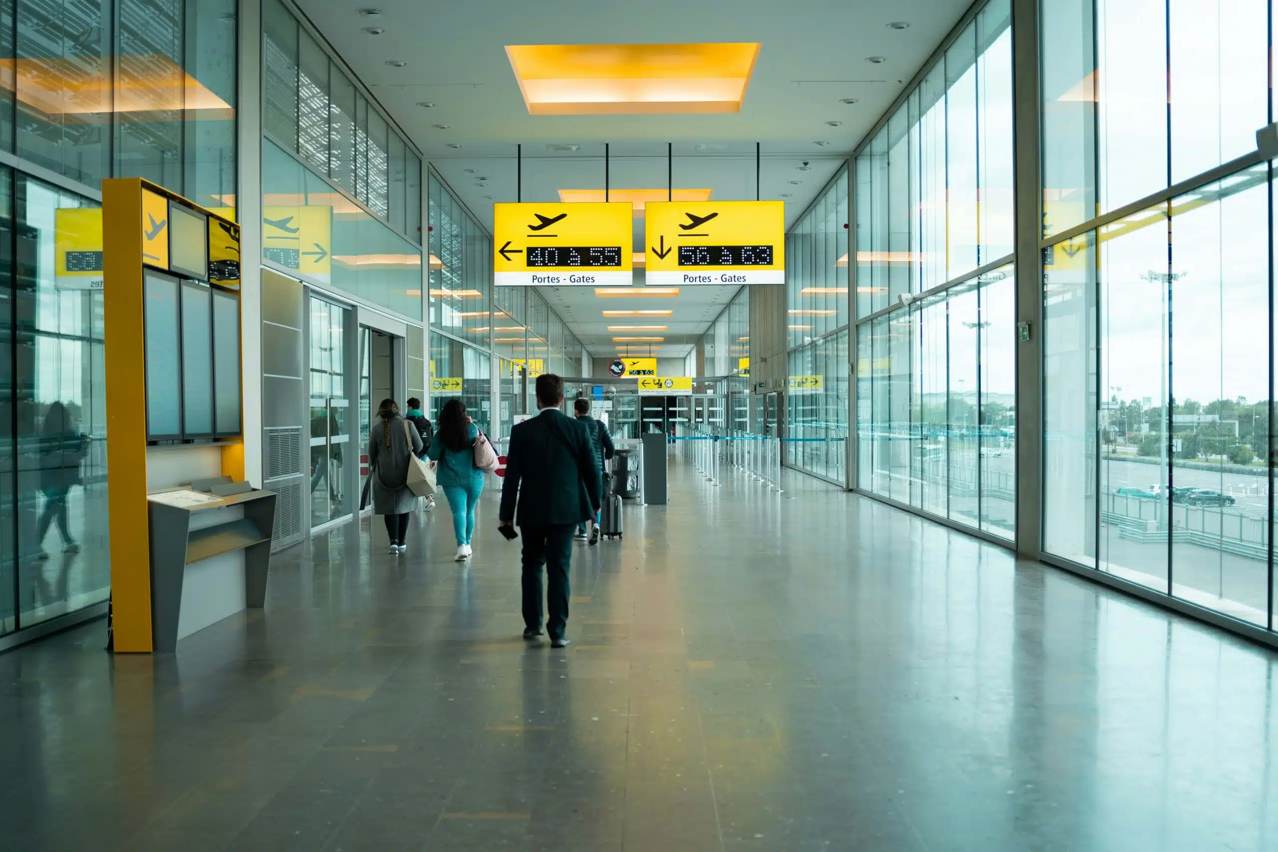 People in airport heading to departure gate | UK eVisa | Immigration Legal Services UK